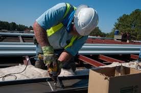 man repairing roof