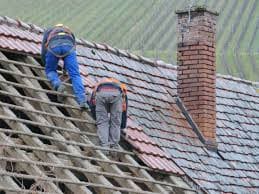 two men fixing roof